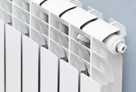 white heating radiator hanging on the wall in the living room, close-upの写真素材