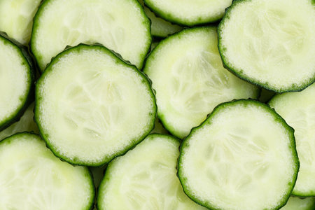 background of fresh sliced cucumber, top viewの写真素材