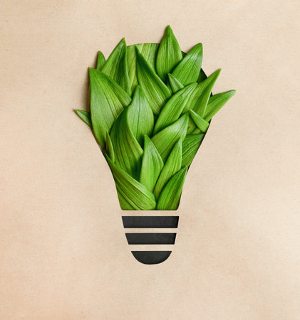 light bulb made of green leaves on a brown background, energy saving concept