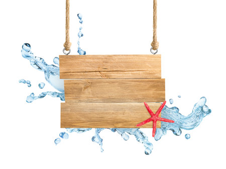 wooden sign hanging on twine with water splashes and starfish on white isolated backgroundの写真素材