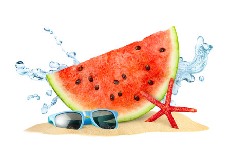 watermelon slice, starfish, sunglasses and water splashes in a pile of sand on a white isolated backgroundの写真素材