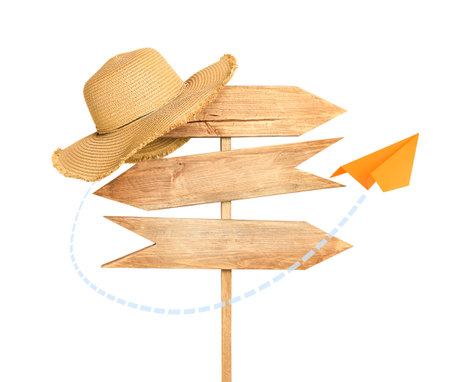 road sign with sun hat and paper flying airplane on white isolated backgroundの写真素材