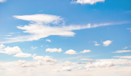 background blue sky with clouds on a clear dayの写真素材