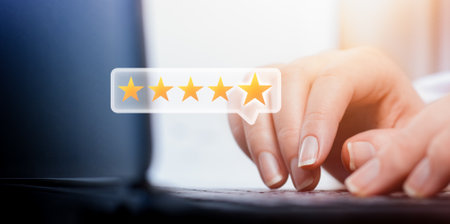 female hands typing on laptop keyboard and hologram in the form of five star scale. customer service rating conceptの写真素材