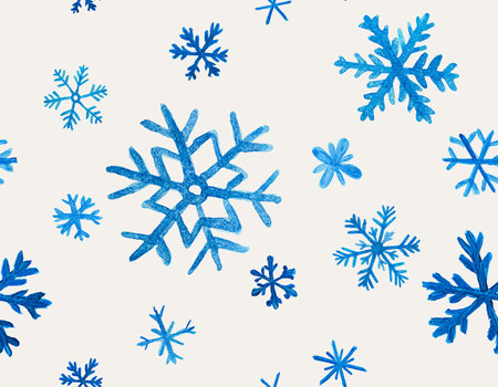seamless pattern with blue snowflakes painted with watercolors on a beige backgroundの写真素材