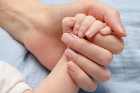 baby's hand in mother's hand, close-upの写真素材