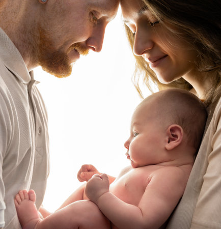 parents and newborn baby in their arms on a light background. family conceptの写真素材