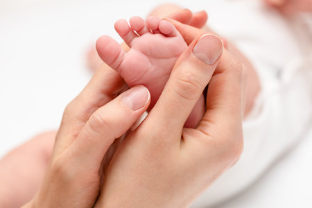 female hands holding baby's little footの写真素材