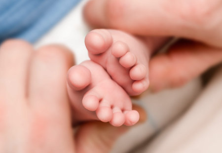 baby's feet in daddy's hands extreme close-up