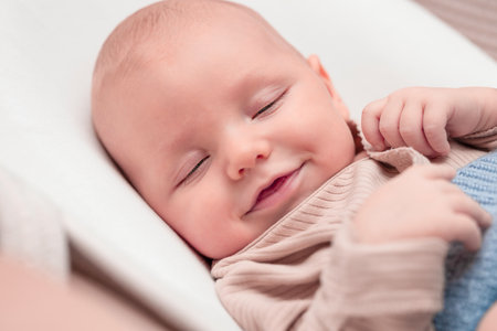 baby sleeps and smiles in his sleepの写真素材