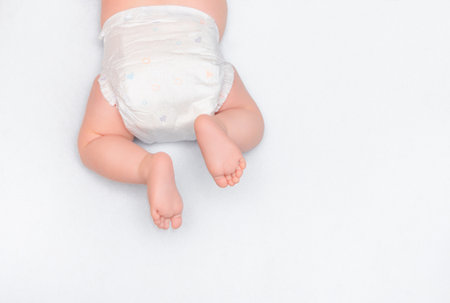 top view of crawling baby, baby's feet in diapers close-up. newborn care conceptの写真素材