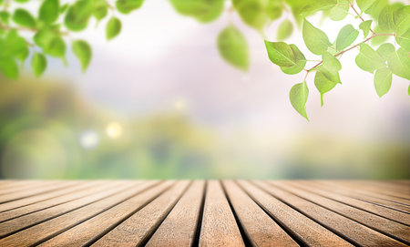 empty wooden table and tree leaves in sun rays, spring backgroundの写真素材
