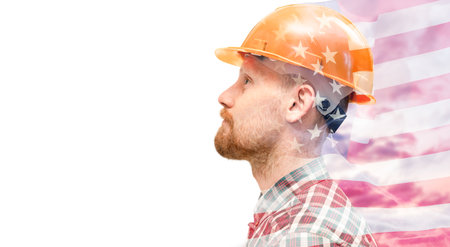 Portrait of a man in a hard hat in profile, with an American flag overlay. Labor Day concept. Isolated on white backgroundの写真素材