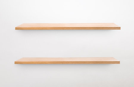 two empty wall shelves on a gray wallの写真素材