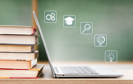 open laptop with holograms on the topic of education, against the background of a school boardの写真素材
