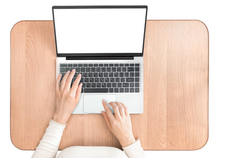 woman with laptop at work desk, isolated on white background, top viewの写真素材