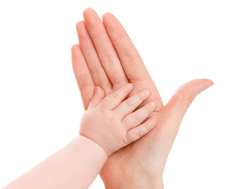 baby hand on mother's palm. concept of family and child care. isolated white backgroundの写真素材