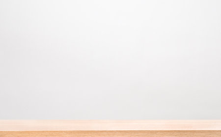 Empty wooden table against gray wall. background for your advertisement presentationの写真素材