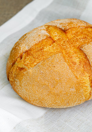 Close-up of whole fresh crispy tasty round shaped wheat bread on a light background. Individual items, baking, side view, top viewの写真素材
