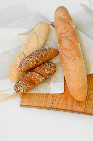 Top view of freshly baked bread, baguette with various seeds (sesame, flax, sunflower) isolated on white background.の写真素材