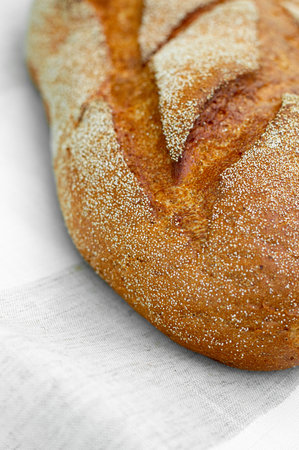 Close-up of fresh crispy tasty oval rye bread on a light background. individual products, baking, top view, side viewの写真素材