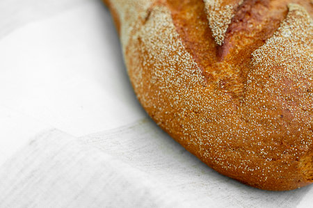 Close-up of fresh crispy tasty oval rye bread on a light background. individual products, baking, top view, side viewの写真素材