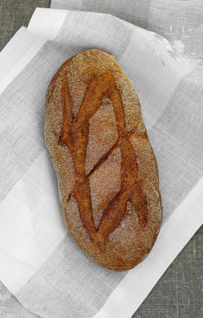 Close-up of fresh crispy tasty oval rye bread on a light background. individual products, baking, top view, side viewの写真素材