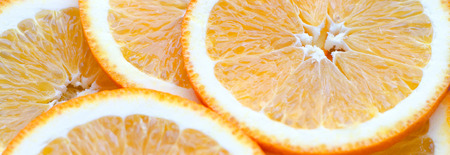 Orange yellow overlapped slices close-up background.の写真素材