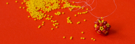 Beads For A Unique Necklace. Wattled beaded bead on an orange background.の写真素材