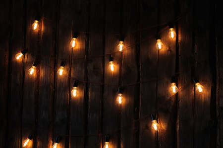 A garland of lamps hanging on the wallの写真素材