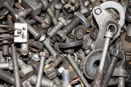 various metal screws, bolts, nuts, screws and other tools are in the box. These things create the background and textureの写真素材