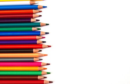 Multi-colored wooden pencils from the right with an empty space for text on a white isolated backgroundの写真素材