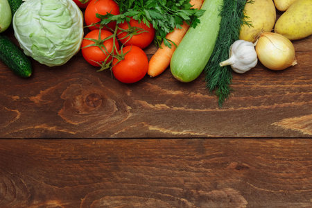 Raw vegetables cucumber, cabbage, tomatoes on a branch, carrots, zucchini, onions, garlic, potatoes...