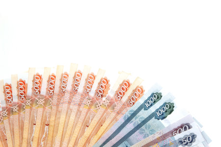 Banknotes of Russian rubles money lie on a white isolated background top view with an empty space...