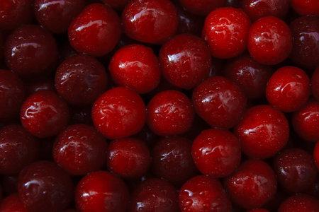 Noise, grain, film effect, out of focus background of ripe berries, ripe red cherry fruits close-up with water dropsの写真素材