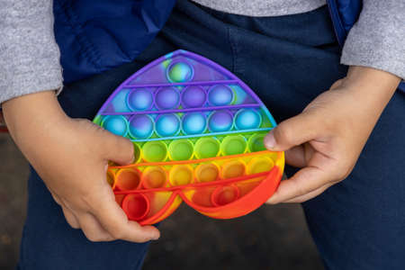 Popular New Fashionable Toy Bubbles Fidget Pop It for children and people with stress. Rainbow Pop It Bubble Touch Toy For Kidsの写真素材