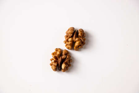 walnut peeled kernel on a white background two halvesの写真素材