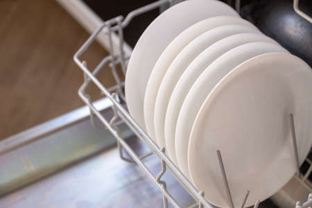 white dishes in the dishwasher, open doorの写真素材
