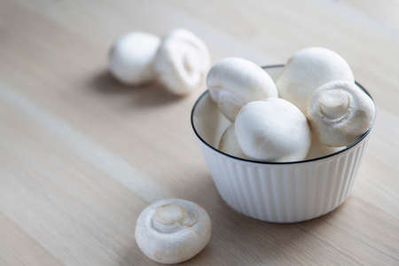 mushrooms champignons in a white plate vegetarian foodの写真素材