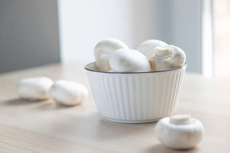mushrooms champignons in a white plate vegetarian foodの写真素材