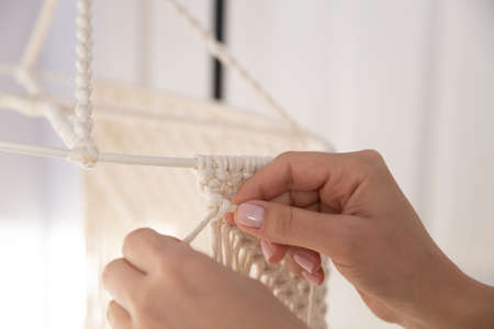 closeup weaving of macrame threads , womens handsの写真素材