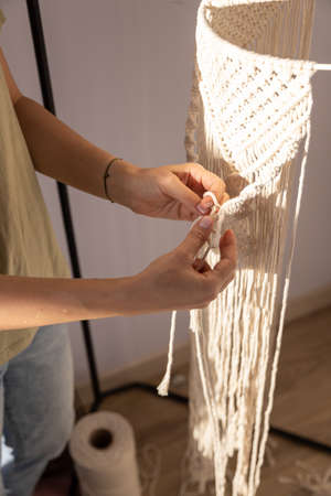 closeup weaving of macrame threads , womens handsの写真素材