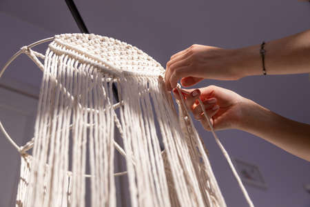 closeup weaving of macrame threads , womens handsの写真素材