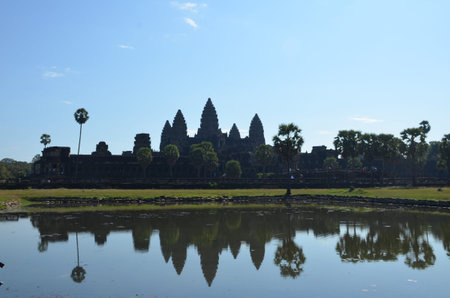 The Angkor Wat temple with five towers is reflected in the lake. Angkor, Cambodia