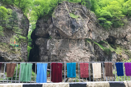 Chegem gorge in Kabardino-Balkaria in North Caucasus, Russia. A row of knitted woolen clothes sold...