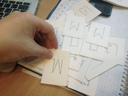 Concept of learning Thai language and the alphabet. Close up of male hand holding card with the...