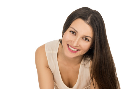 young woman on white background smiling with brown hair and brown eyes, isolated. fashion and beauty. beautiful brunette. girl looking at the camera. flowing hair and natural makeupの写真素材