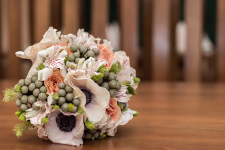 beautiful bridal bouquet of lilies and roses on the tableの写真素材