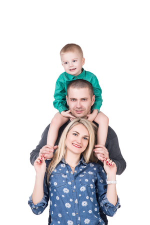 happy young family with child smiling and posing on white, isolatedの写真素材