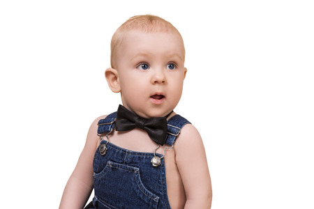 cute surprised baby boy looking aside, isolated on whiteの写真素材